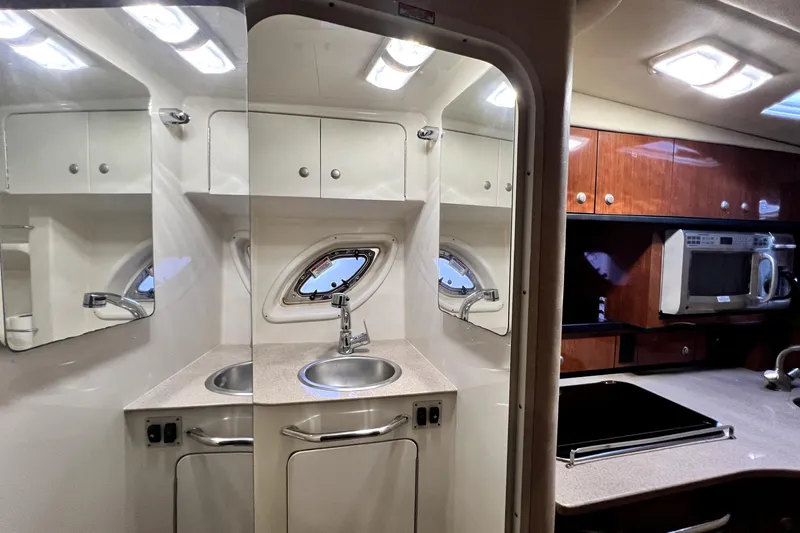 Slide: The Image of 2007 Sea Ray Sundancer 310 interior with kitchenette, sink, and microwave. - 35