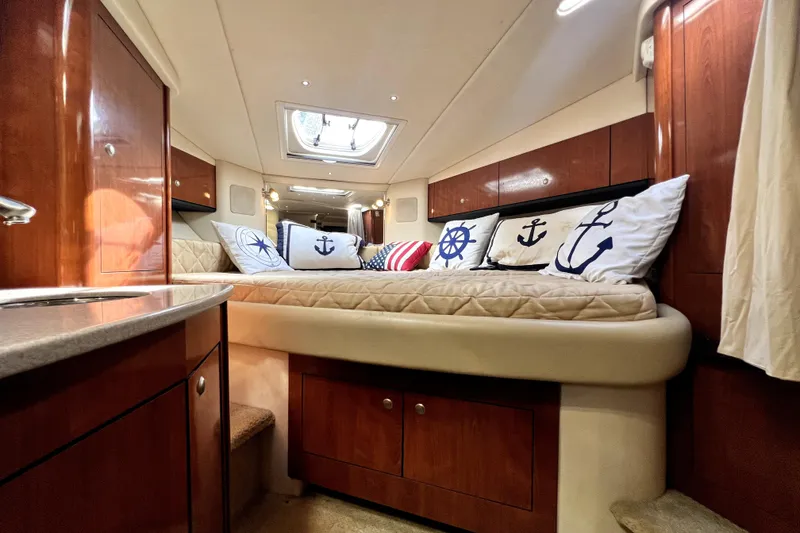 Slide: The Image of Luxurious 2007 Sea Ray Sundancer 310 cabin with nautical-themed pillows and elegant wood finishes. - 38
