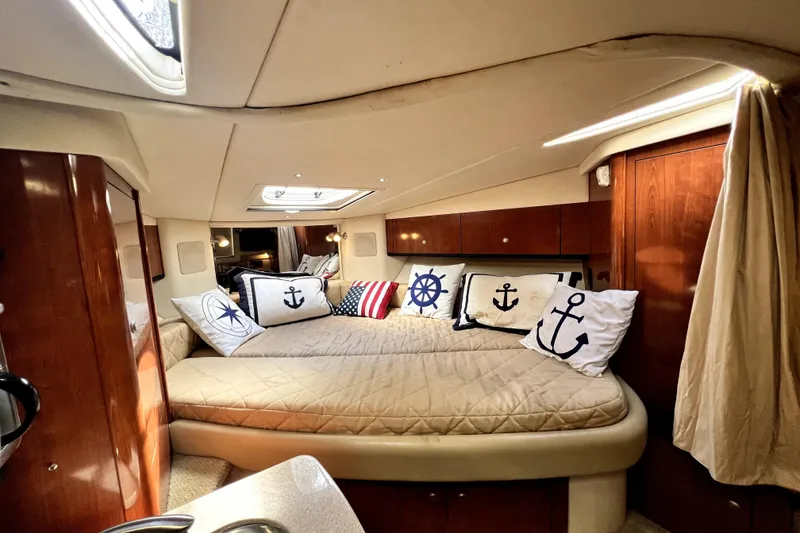 Slide: The Image of Luxurious 2007 Sea Ray Sundancer 310 cabin interior with nautical-themed decor and cozy bedding. - 43