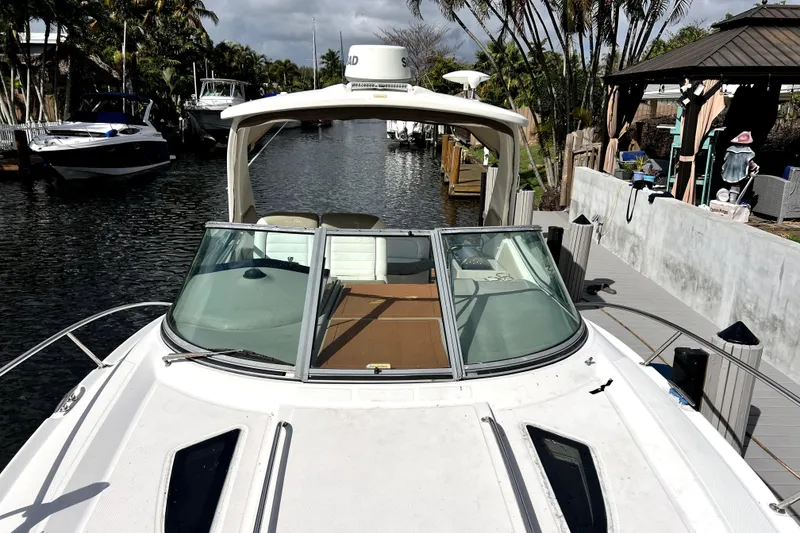 Slide: The Image of 2007 Sea Ray Sundancer 310 docked in a scenic canal setting. - 47