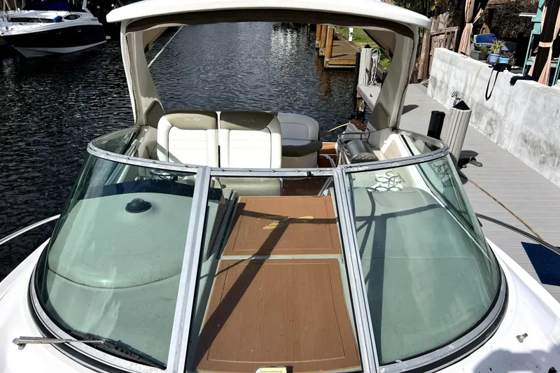 Slide: The Image of 2007 Sea Ray Sundancer 310 docked, showcasing spacious deck and seating area. - 48