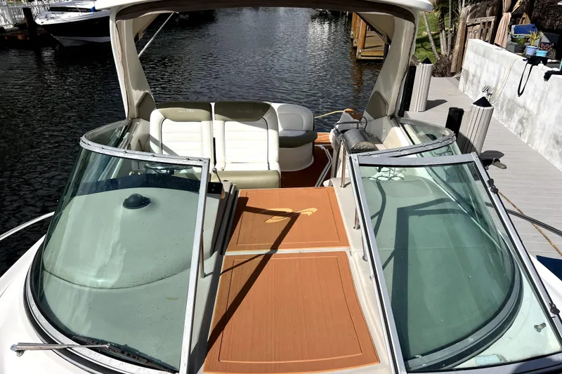 Slide: The Image of 2007 Sea Ray Sundancer 310 boat docked, featuring spacious seating and sleek design. - 50