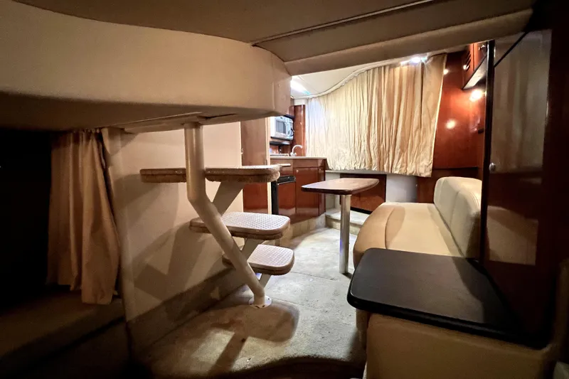 Slide: The Image of Interior of 2007 Sea Ray Sundancer 310 yacht with seating, table, and kitchenette. - 58