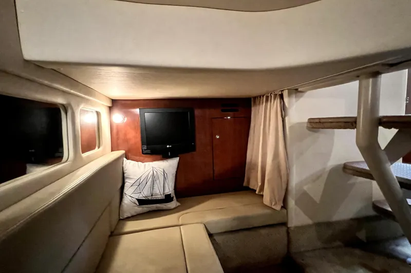 Slide: The Image of 2007 Sea Ray Sundancer 310 cabin interior with TV, cushion, and wooden accents. - 62
