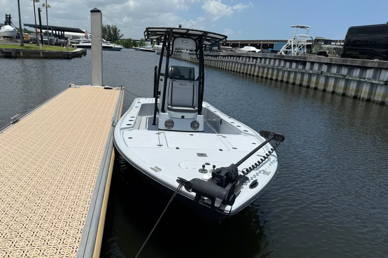 The Image of 2017 Yellowfin 24 Bay CE boat docked at marina under clear sky. - 1