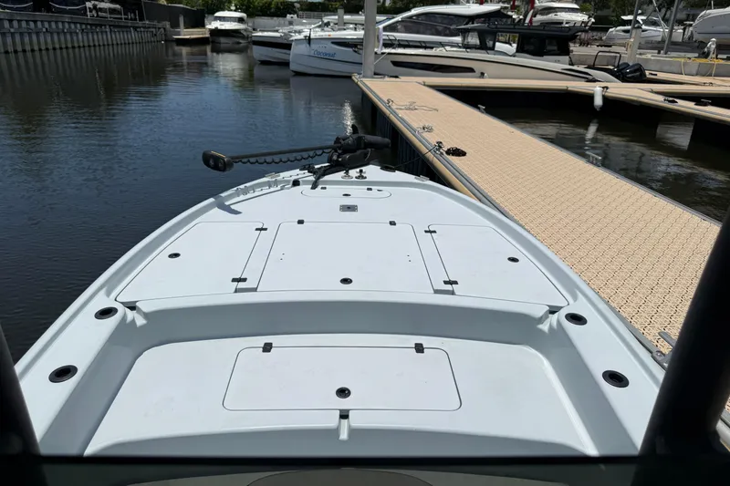 Slide: The Image of 2017 Yellowfin 24 Bay CE boat docked at marina, showcasing spacious deck and sleek design. - 10