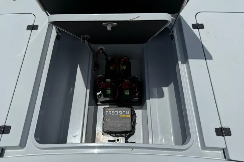 Slide: The Image of 2017 Yellowfin 24 Bay CE boat battery compartment with Precision charger. - 15