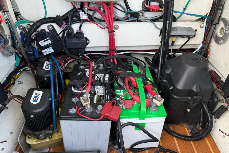 Slide: The Image of 2017 Yellowfin 24 Bay CE boat battery compartment with wiring and components. - 23