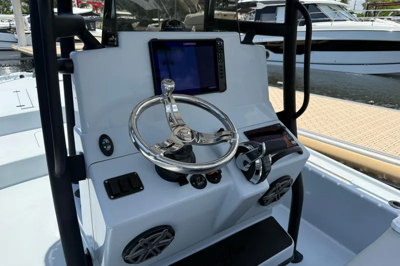 Slide: The Image of 2017 Yellowfin 24 Bay CE boat console with steering wheel and navigation system. - 29