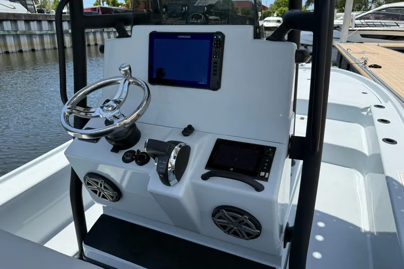 Slide: The Image of 2017 Yellowfin 24 Bay CE boat console with steering wheel and navigation screens. - 30