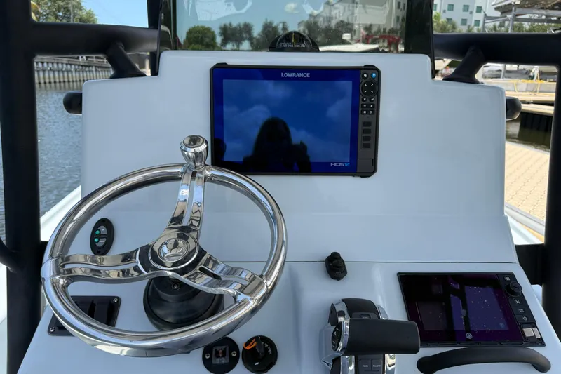 Slide: The Image of 2017 Yellowfin 24 Bay CE boat dashboard with steering wheel and navigation screens. - 31