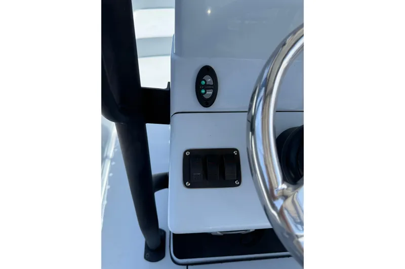 Slide: The Image of 2017 Yellowfin 24 Bay CE boat console with steering wheel and control switches. - 39