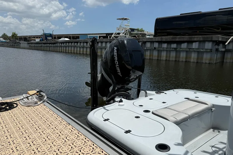 Slide: The Image of 2017 Yellowfin 24 Bay CE boat docked, featuring a Mercury outboard motor. - 4