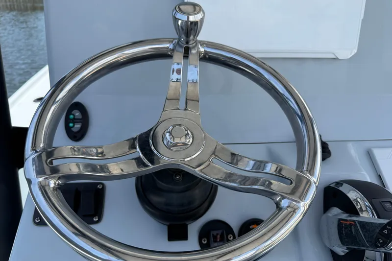 Slide: The Image of Steering wheel of a 2017 Yellowfin 24 Bay CE boat, showcasing sleek design. - 40