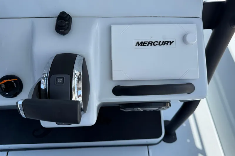 Slide: The Image of Close-up of 2017 Yellowfin 24 Bay CE boat controls with Mercury branding. - 41