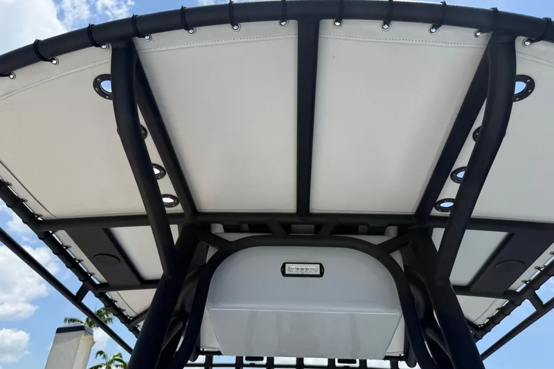 Slide: The Image of 2017 Yellowfin 24 Bay CE boat canopy with sturdy black frame and white cover. - 45