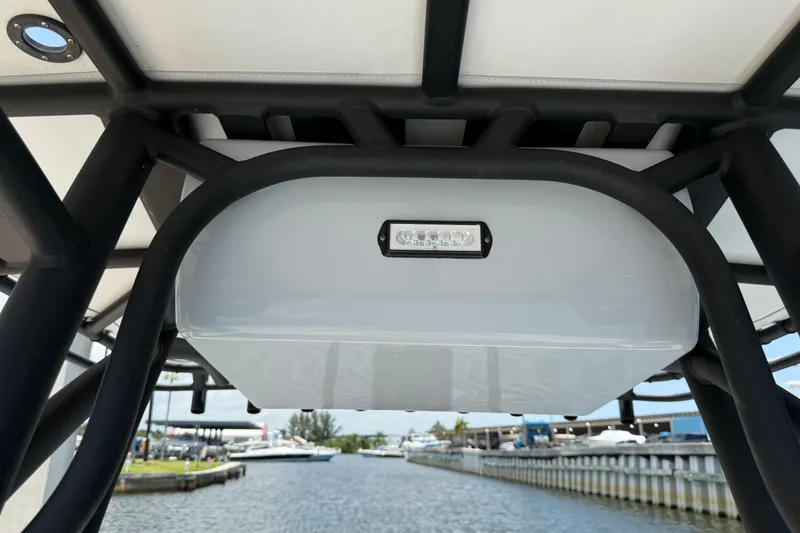 Slide: The Image of 2017 Yellowfin 24 Bay CE boat canopy with LED light, dockside view. - 47
