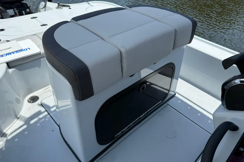 Slide: The Image of 2017 Yellowfin 24 Bay CE boat interior with cushioned seating and storage compartment. - 50