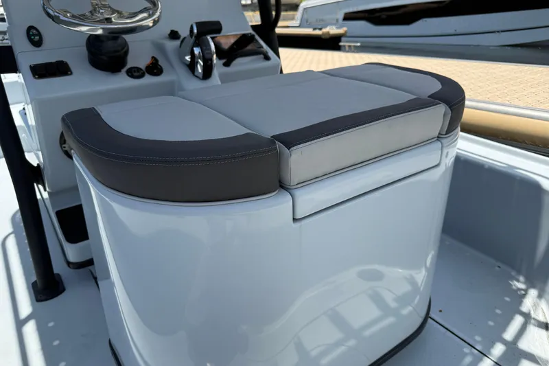 Slide: The Image of 2017 Yellowfin 24 Bay CE boat console with cushioned seating and steering controls. - 51