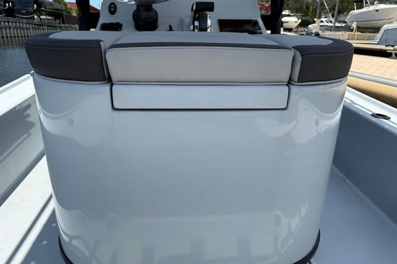 Slide: The Image of 2017 Yellowfin 24 Bay CE boat interior with cushioned seating and control panel. - 52