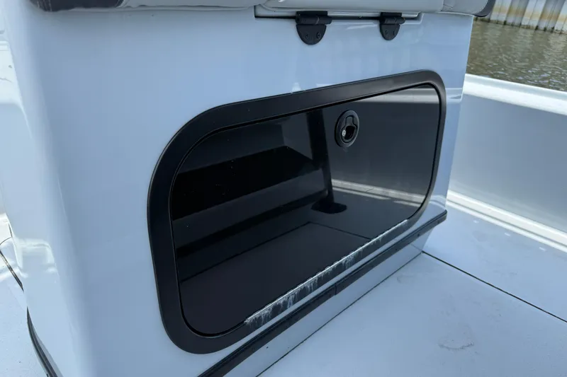 Slide: The Image of 2017 Yellowfin 24 Bay CE boat storage compartment, sleek design, black and white finish. - 55