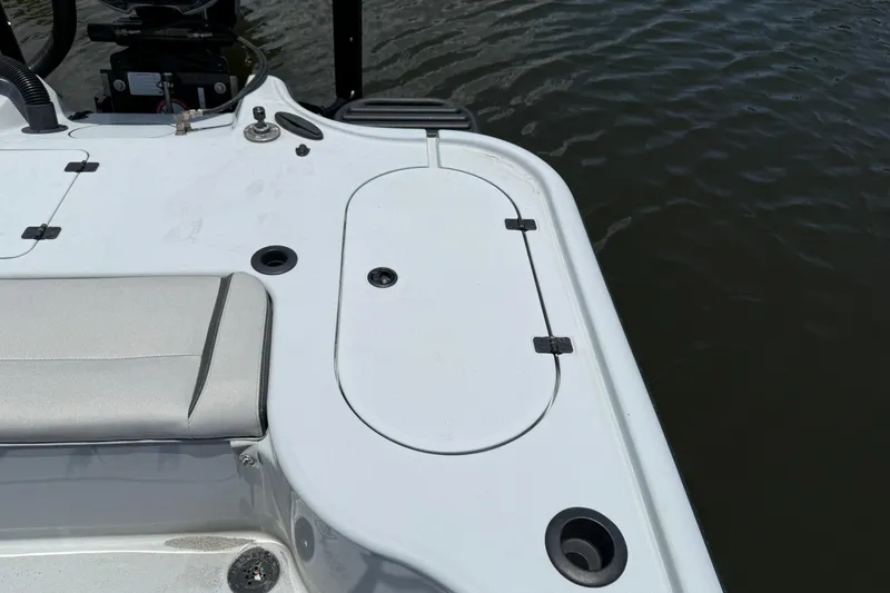 Slide: The Image of 2017 Yellowfin 24 Bay CE boat deck with storage compartment and seating, near water. - 58