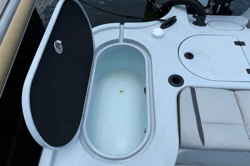 Slide: The Image of Open storage compartment on a 2017 Yellowfin 24 Bay CE boat, showcasing interior space. - 63