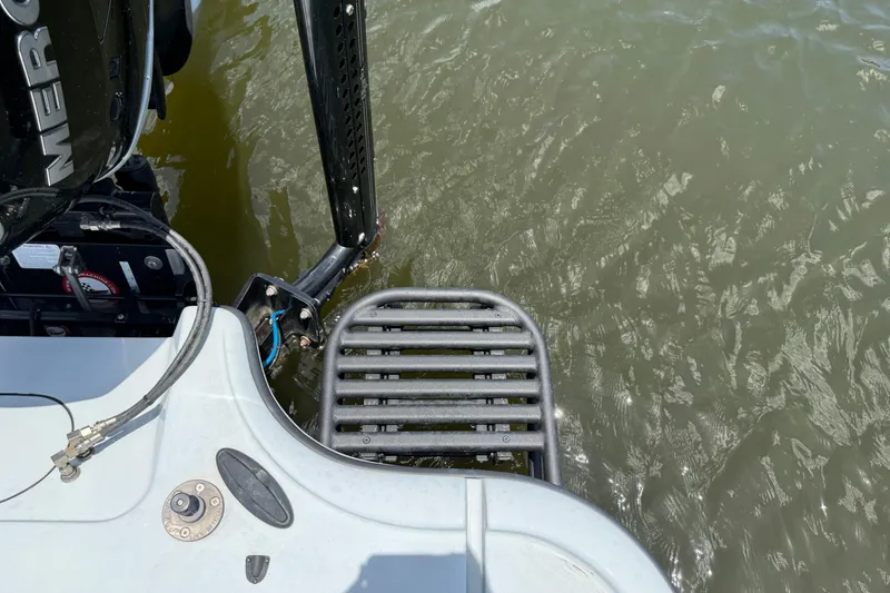 Slide: The Image of 2017 Yellowfin 24 Bay CE boat with Mercury engine, rear view near water. - 66