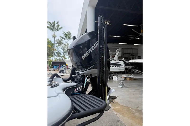 Slide: The Image of 2017 Yellowfin 24 Bay CE boat with Mercury outboard motor in a marina setting. - 76