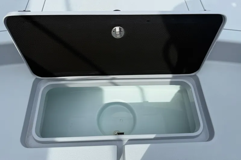 Slide: The Image of Open storage compartment on 2017 Yellowfin 24 Bay CE boat. - 77