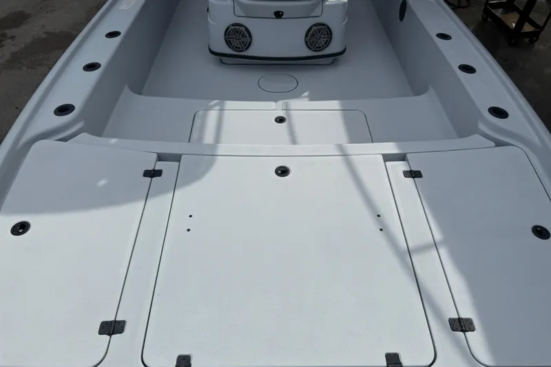 Slide: The Image of 2017 Yellowfin 24 Bay CE boat deck with storage compartments and speaker system. - 83