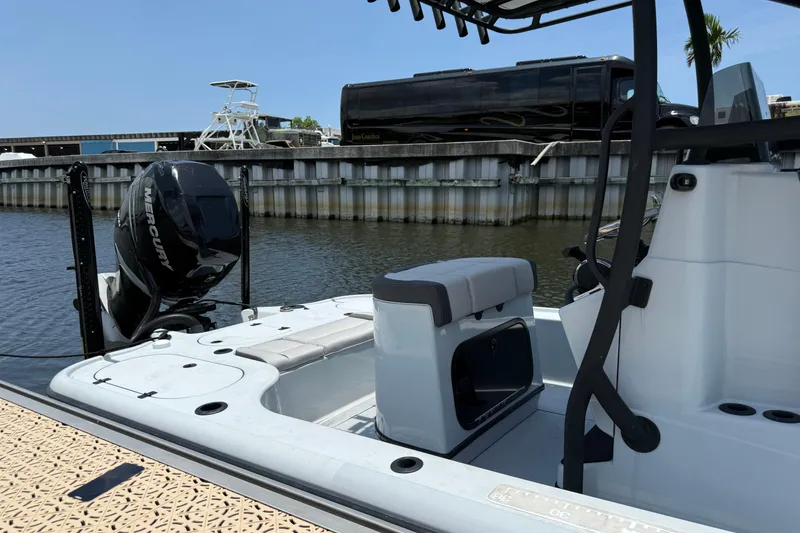 Slide: The Image of 2017 Yellowfin 24 Bay CE boat docked, featuring a Mercury outboard motor. - 9