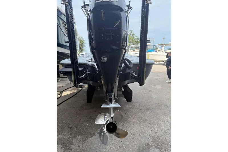Slide: The Image of 2017 Yellowfin 24 Bay CE boat rear view with motor and propeller. - 96