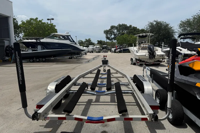 Slide: The Image of Boat trailer at marina, surrounded by various boats, including a 2017 Yellowfin 24 Bay CE. - 97