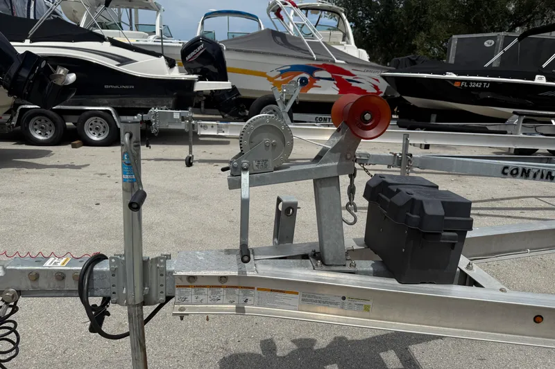 Slide: The Image of Boat trailer with winch and battery box, surrounded by various boats, including a 2017 Yellowfin 24 Bay CE. - 98