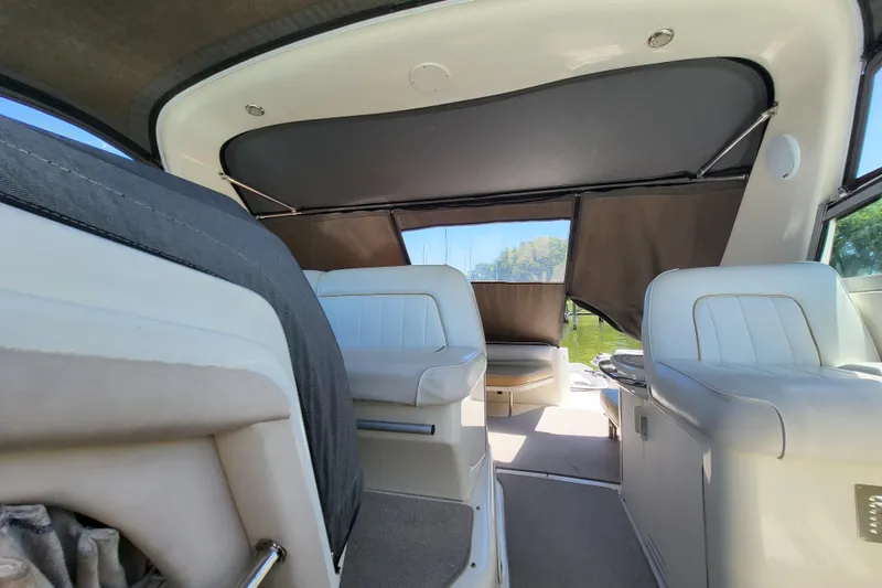 Slide: The Image of Interior of a 1995 Sea Ray Sundancer 370 boat with white seating and canopy. - 11