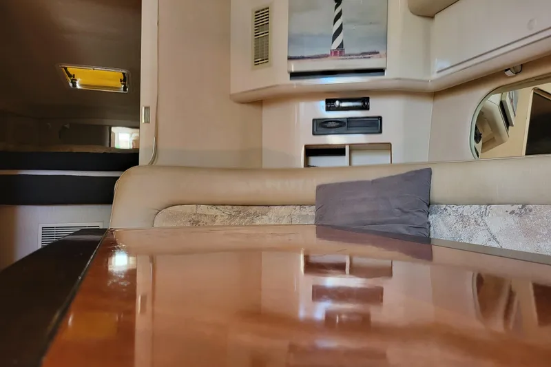 Slide: The Image of Interior of 1995 Sea Ray Sundancer 370 yacht with polished table and cozy seating. - 15