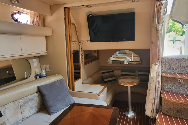 Slide: The Image of Interior of a 1995 Sea Ray Sundancer 370 yacht with cozy seating and modern amenities. - 16