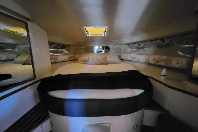 Slide: The Image of Interior cabin of a 1995 Sea Ray Sundancer 370 yacht, featuring a cozy bed. - 17