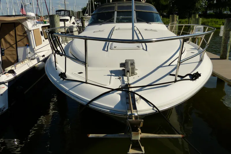 Slide: The Image of 1995 Sea Ray Sundancer 370 docked at marina, front view with railing and anchor. - 21