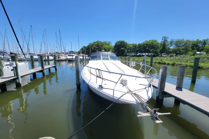 Slide: The Image of 1995 Sea Ray Sundancer 370 docked at a marina on a sunny day. - 22