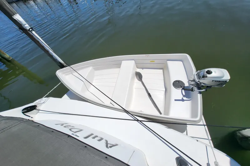 Slide: The Image of Small boat with Honda motor docked beside 1995 Sea Ray Sundancer 370. - 24