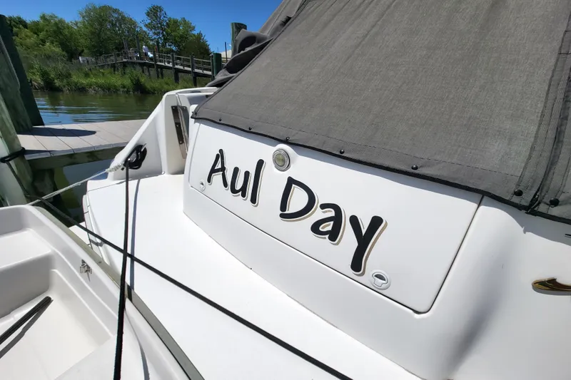 Slide: The Image of 1995 Sea Ray Sundancer 370 boat named "Aul Day" docked by the water. - 25