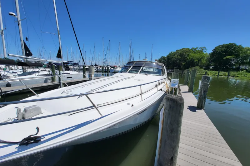 Slide: The Image of 1995 Sea Ray Sundancer 370 docked at a marina on a sunny day. - 26