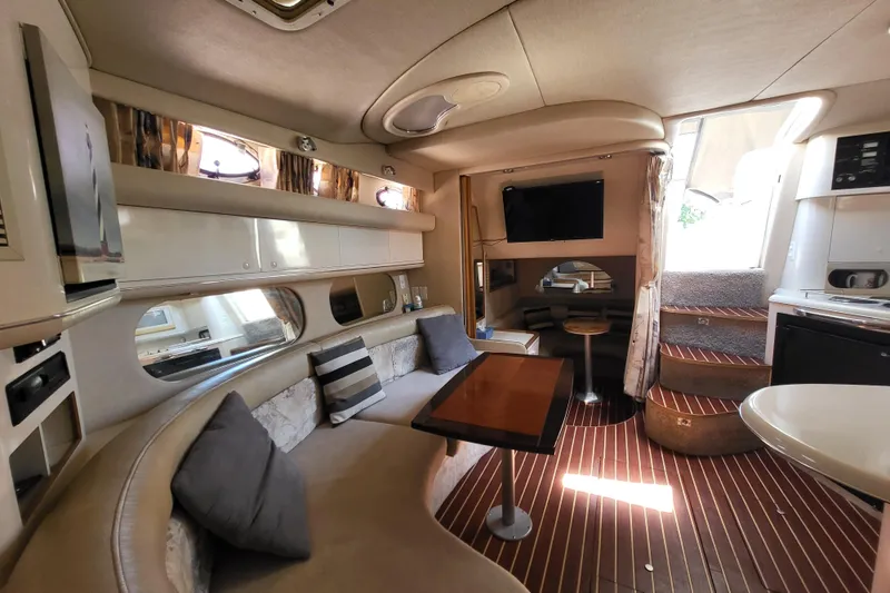 Slide: The Image of Interior of a 1995 Sea Ray Sundancer 370 yacht, featuring a cozy seating area and modern amenities. - 3