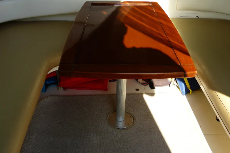 Slide: The Image of Interior of 1995 Sea Ray Sundancer 370 with wooden table and cushioned seating. - 30