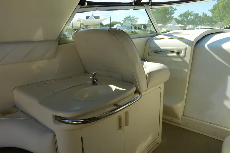 Slide: The Image of Interior of a 1995 Sea Ray Sundancer 370 yacht, featuring a compact sink and seating area. - 31
