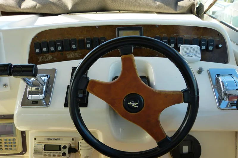 Slide: The Image of Steering wheel and controls of a 1995 Sea Ray Sundancer 370 boat. - 38