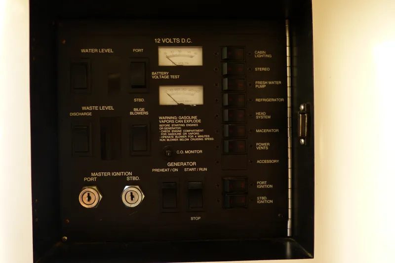 Slide: The Image of Control panel of a 1995 Sea Ray Sundancer 370 boat, featuring various switches and gauges. - 46