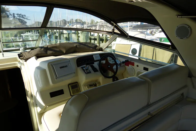 Slide: The Image of Interior view of 1995 Sea Ray Sundancer 370 helm with steering wheel and navigation equipment. - 49